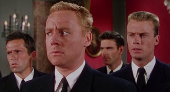 Movie still from “The Caine Mutiny” (1954), directed by Edward Dmytryk – A group of men standing next to each other in suits; Close Up shot, Low angle