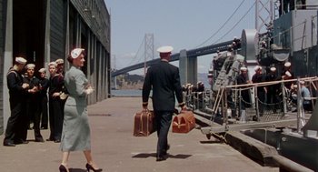 Movie still from “The Caine Mutiny” (1954), directed by Edward Dmytryk – A man and a woman walking down a sidewalk; Wide shot, Low angle