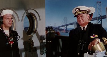 Movie still from “The Caine Mutiny” (1954), directed by Edward Dmytryk – A man in a uniform standing in front of a bridge; Medium shot, Low angle