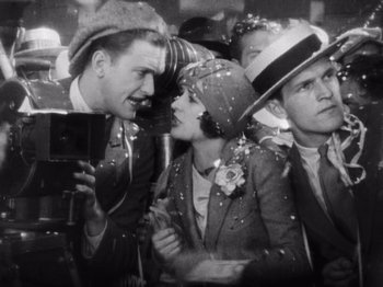 Movie still from “The Cameraman” (1928), directed by Buster Keaton – An old black and white photo of a group of people; Medium shot, Low angle