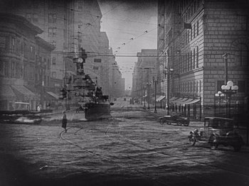Movie still from “The Cameraman” (1928), directed by Buster Keaton – A black and white photo of a city street; Extreme Wide shot, High angle