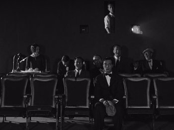 Movie still from “The Cameraman” (1928), directed by Buster Keaton – A group of people sitting in a theater; Wide shot, High angle