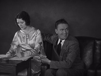 Movie still from “The Cameraman” (1928), directed by Buster Keaton – A man and a woman sitting next to each other on a couch; Medium shot, High angle