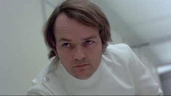 Movie still from “The Cassandra Crossing” (1976), directed by George P. Cosmatos – A person wearing a white shirt; Close Up shot, Low angle