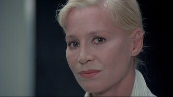 Movie still from “The Cassandra Crossing” (1976), directed by George P. Cosmatos – A woman's face in a black background; Close Up shot, Over the shoulder angle