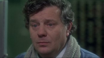 Movie still from “The Cassandra Crossing” (1976), directed by George P. Cosmatos – A person wearing a sweater; Close Up shot, Over the shoulder angle