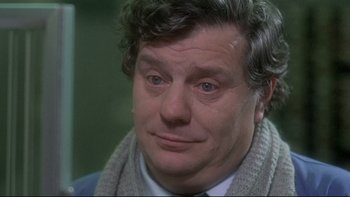 Movie still from “The Cassandra Crossing” (1976), directed by George P. Cosmatos – A person wearing a tie; Close Up shot, Over the shoulder angle