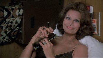 Movie still from “The Cassandra Crossing” (1976), directed by George P. Cosmatos – A beautiful woman holding a cell phone in her hand; Close Up shot, Low angle