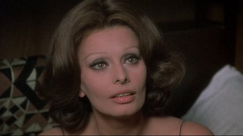 Movie still from “The Cassandra Crossing” (1976), directed by George P. Cosmatos – A person wearing a dress; Close Up shot, Over the shoulder angle