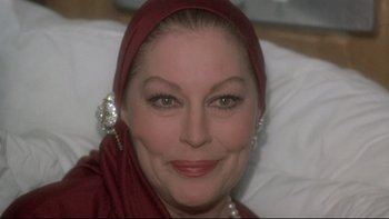 Movie still from “The Cassandra Crossing” (1976), directed by George P. Cosmatos – A person wearing a headscarf; Close Up shot, Over the shoulder angle