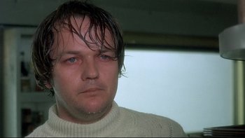 Movie still from “The Cassandra Crossing” (1976), directed by George P. Cosmatos – A person wearing a sweater; Close Up shot, Low angle