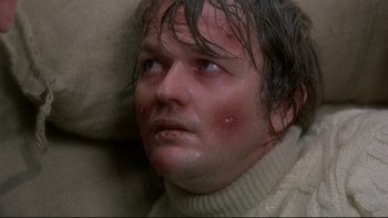 Movie still from “The Cassandra Crossing” (1976), directed by George P. Cosmatos – A person wearing a sweater; Close Up shot, High angle