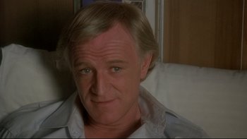 Movie still from “The Cassandra Crossing” (1976), directed by George P. Cosmatos – A person wearing a white shirt; Close Up shot, Low angle