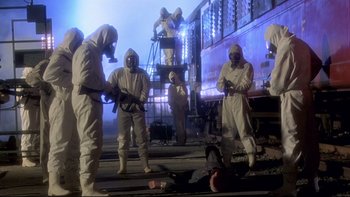Movie still from “The Cassandra Crossing” (1976), directed by George P. Cosmatos – A group of people in white suits and masks; Wide shot, High angle