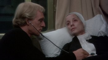 Movie still from “The Cassandra Crossing” (1976), directed by George P. Cosmatos – An older man and a younger woman are in a hospital bed; Close Up shot, High angle