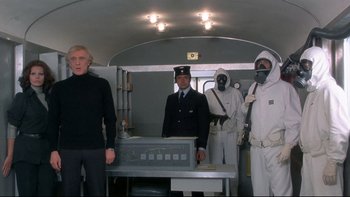 Movie still from “The Cassandra Crossing” (1976), directed by George P. Cosmatos – A group of people standing next to each other in a room; Medium shot, Low angle