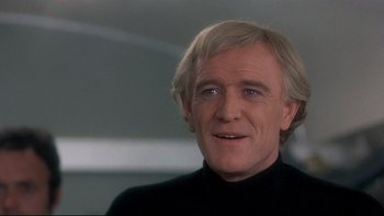 Movie still from “The Cassandra Crossing” (1976), directed by George P. Cosmatos – A person wearing a black shirt; Close Up shot, Low angle