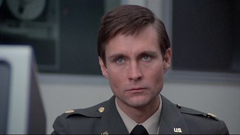 Movie still from “The Cassandra Crossing” (1976), directed by George P. Cosmatos – A person wearing a military uniform; Close Up shot, Low angle