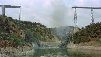 Movie still from “The Cassandra Crossing” (1976), directed by George P. Cosmatos – An image of a bridge over a body of water; Extreme Wide shot, High angle