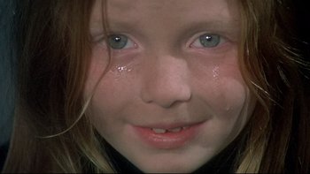 Movie still from “The Cassandra Crossing” (1976), directed by George P. Cosmatos – A young girl's face with tears coming out of her eyes; Extreme Close Up shot, High angle