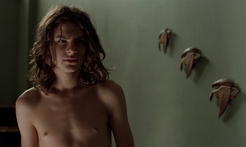 Movie still from “The Cement Garden” (1993), directed by Andrew Birkin – A naked woman standing in front of a wall; Close Up shot, Low angle