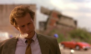 Movie still from “The Cement Garden” (1993), directed by Andrew Birkin – A person wearing a suit and tie; Close Up shot, Low angle