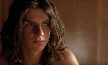 Movie still from “The Cement Garden” (1993), directed by Andrew Birkin – A person with long brown hair; Close Up shot, Low angle