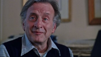 Movie still from “The Changeling” (1980), directed by Peter Medak – An older man with grey hair looking at the camera; Close Up shot, Low angle