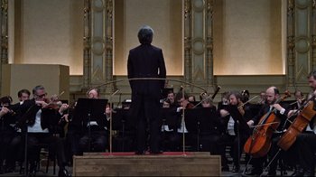 Movie still from “The Changeling” (1980), directed by Peter Medak – A man standing in front of a group of people; Wide shot, Low angle