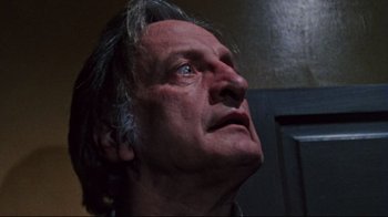Movie still from “The Changeling” (1980), directed by Peter Medak – An older man looking up into the sky; Close Up shot, Low angle