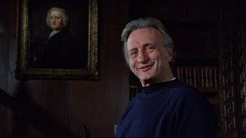 Movie still from “The Changeling” (1980), directed by Peter Medak – A man smiling in front of a portrait of a woman; Close Up shot, Low angle