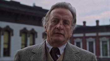 Movie still from “The Changeling” (1980), directed by Peter Medak – An older man wearing a suit and a tie; Close Up shot, Low angle