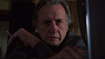 Movie still from “The Changeling” (1980), directed by Peter Medak – An older man with grey hair is looking at the camera; Close Up shot, Low angle