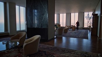 Movie still from “The Changeling” (1980), directed by Peter Medak – A room filled with furniture and a fireplace; Extreme Wide shot, High angle