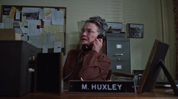 Movie still from “The Changeling” (1980), directed by Peter Medak – An older woman sitting at a desk talking on the phone; Close Up shot, Low angle