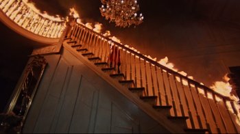 Movie still from “The Changeling” (1980), directed by Peter Medak – A staircase that is lit up by a chandelier; Wide shot, Low angle