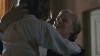 Movie still from “The Childhood of a Leader” (2015), directed by Brady Corbet – An older woman is hugging a younger woman; Close Up shot, Over the shoulder angle