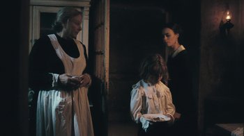 Movie still from “The Childhood of a Leader” (2015), directed by Brady Corbet – Two women and a child in a room; Medium shot, Over the shoulder angle