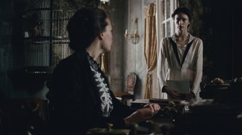 Movie still from “The Childhood of a Leader” (2015), directed by Brady Corbet – Two women are sitting at a dining room table; Medium shot, Over the shoulder angle