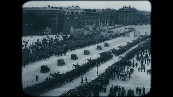 Movie still from “The Childhood of a Leader” (2015), directed by Brady Corbet – A large crowd of people are lined up in a parade; Extreme Wide shot, High angle