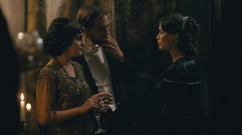 Movie still from “The Childhood of a Leader” (2015), directed by Brady Corbet – A group of people standing next to each other in a room; Medium shot, Over the shoulder angle