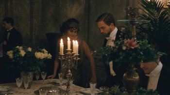Movie still from “The Childhood of a Leader” (2015), directed by Brady Corbet – A man and a woman standing in front of a dinner table; Medium shot, High angle
