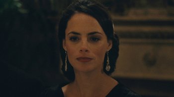 Movie still from “The Childhood of a Leader” (2015), directed by Brady Corbet – A person wearing a black dress; Close Up shot, Over the shoulder angle