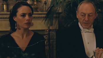 Movie still from “The Childhood of a Leader” (2015), directed by Brady Corbet – A man and a woman standing next to each other in a room; Close Up shot, Over the shoulder angle