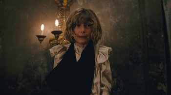 Movie still from “The Childhood of a Leader” (2015), directed by Brady Corbet – A young girl wearing a black and white dress; Medium shot, Low angle