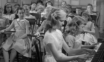Movie still from “The Children's Hour” (1961), directed by William Wyler – A group of young children sitting in a room; Medium shot, Low angle