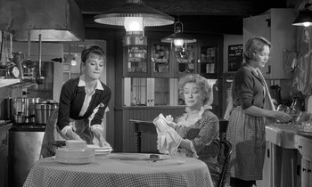 Movie still from “The Children's Hour” (1961), directed by William Wyler – Two women in a kitchen preparing a meal together; Medium shot, High angle