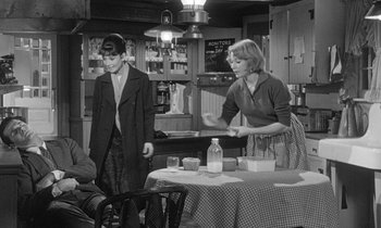 Movie still from “The Children's Hour” (1961), directed by William Wyler – A woman and a boy standing at a dining table; Medium shot, High angle