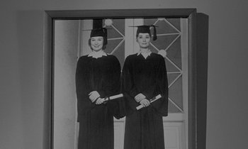 Movie still from “The Children's Hour” (1961), directed by William Wyler – Two women in graduation robes holding their diplomas; Medium shot, Low angle
