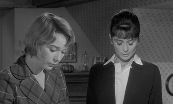 Movie still from “The Children's Hour” (1961), directed by William Wyler – Two women standing next to each other in front of a fireplace; Medium shot, Low angle